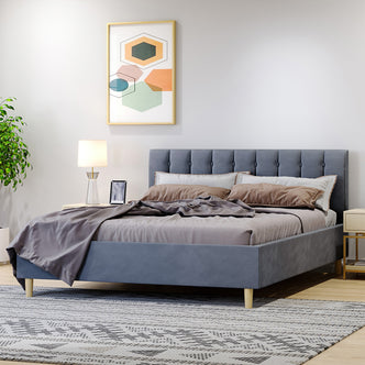 Kelly Velvet Bed Frame – Grey: Features a plush rectangular headboard with vertical tufting, mid-century-inspired legs, and a solid wood frame with metal support, ideal for modern bedroom interiors.