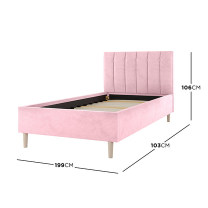 Kelly Single Velvet Fabric Bed Frame in Pink, featuring a vertically channel-tufted headboard, slatted base, and tapered wooden legs. Dimensions: 199 cm (length), 103 cm (width), 106 cm (headboard height).
