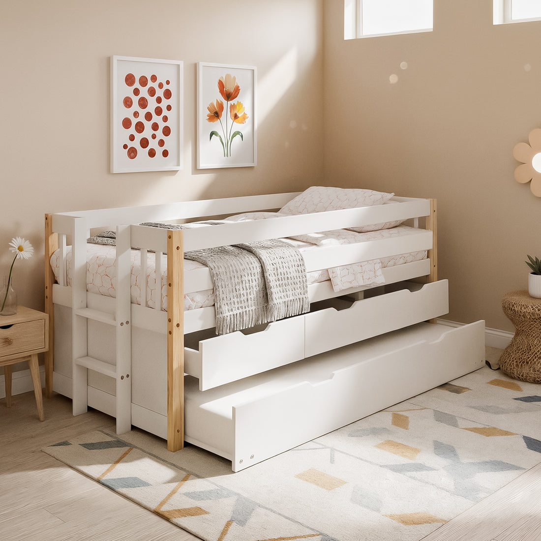 Kiki Kids Trundle Bed with Storage Drawers in White and Natural features a white day-bed with safety rails, pull-out trundle, and two storage drawers, complemented by cozy bedding and decor.