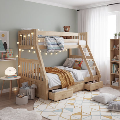 Kourtney Hardwood Triple Bunk Bed with Drawers in Natural, featuring a twin-over-full design, soft linens, fairy lights, a teddy bear, and underbed storage drawers in a cozy kids’ bedroom setting.