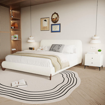 The Laryn Queen Plush Boucle Cloud Bed Frame in Cream White is showcased, featuring a luxurious upholstered platform with a puffy headboard, set in a serene, modern bedroom with minimalist decor.