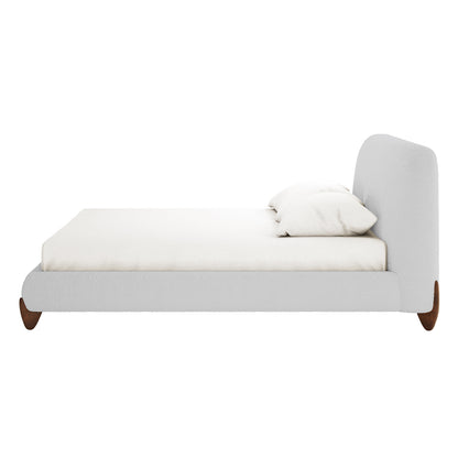 Laryn Queen Plush Bouclé Cloud Bed Frame in Light Grey with a low-profile design, padded headboard, and short wooden feet, showcasing its minimalist elegance and inviting comfort against a plain backdrop.