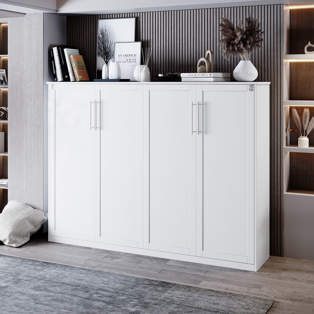 Leeton Space-Saving Queen Foldout Wall Bed White, resembling a low storage cabinet with metal handles, set against a dark wood accent wall, surrounded by decorative items and built-in shelves.