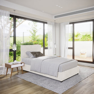 Lovita Single Bouclé Bed Frame with Gas Lift Storage in cream white, upholstered, with a light gray duvet and pillows, beside a wooden nightstand, in a modern, light-filled bedroom.