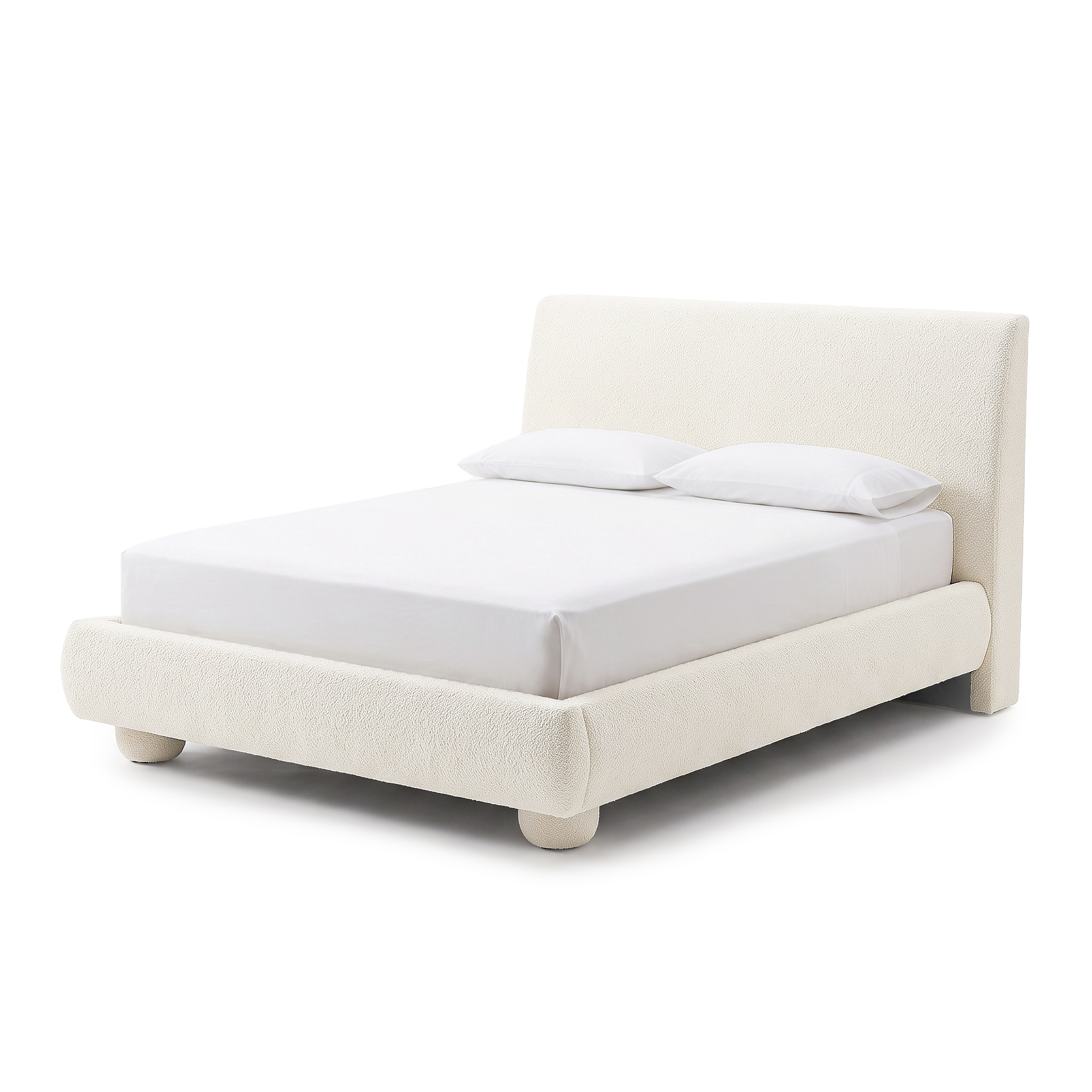 Modern upholstered bed on a white background with white bedding and pillows