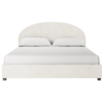 Lunia Super King Bouclé Bed Frame with Gas Lift Storage – Cream White features a low platform base, arch-shaped headboard, white bedding, and pillows in plush cream bouclé fabric, viewed from the foot.