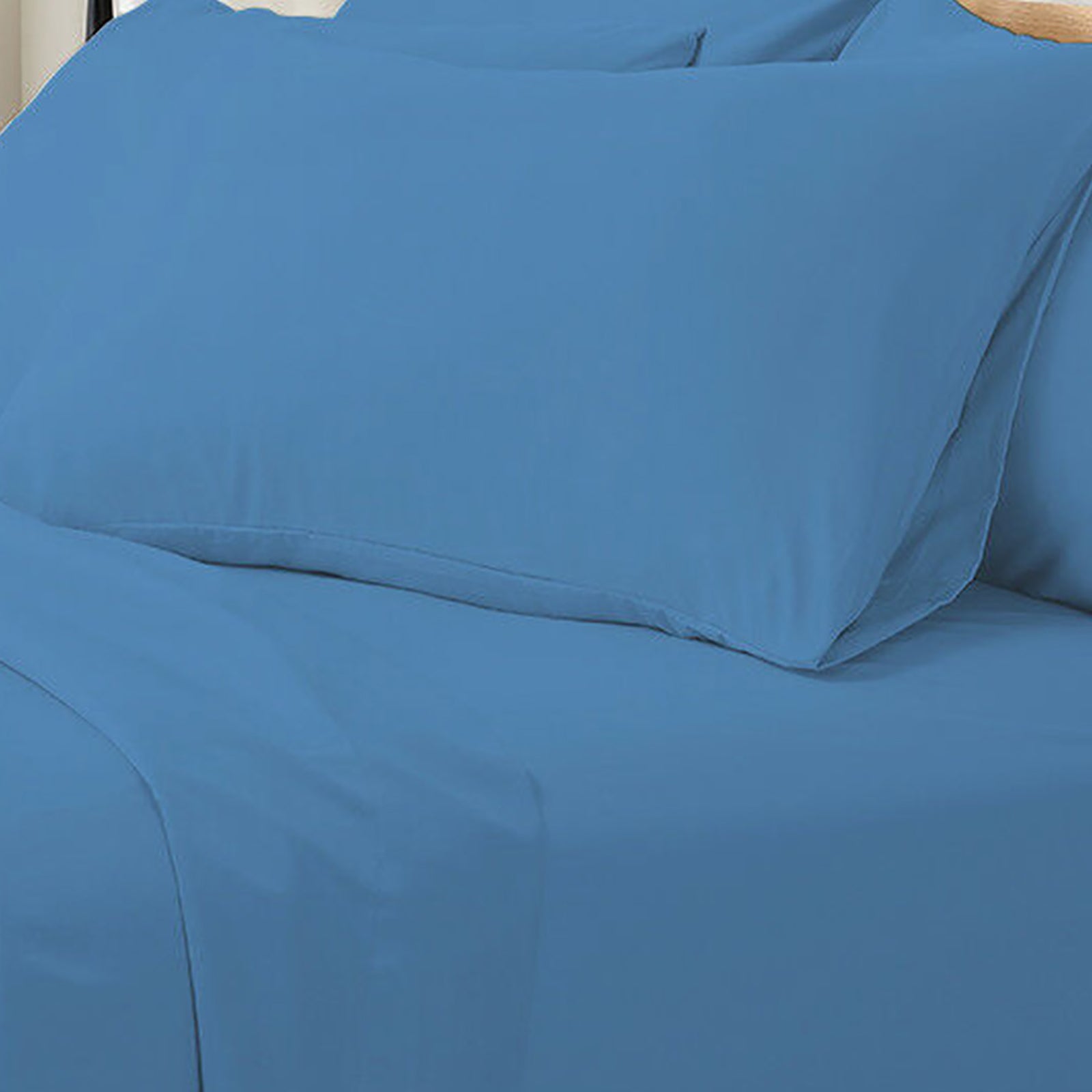 Valeria King 1000TC Ultra Soft Bed Sheet Set in Blue, featuring a close-up of smooth, solid blue bedding with a matching pillowcase on a flat sheet, showcasing luxurious texture and serene style.