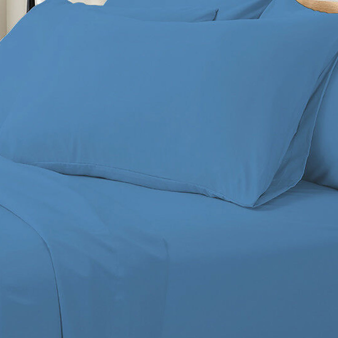 Valeria King Single 1000TC Ultra Soft Bed Sheet Set in Blue; close-up of bed with solid blue fitted sheet and matching pillowcase, showcasing luxurious, smooth fabric texture and neat arrangement.
