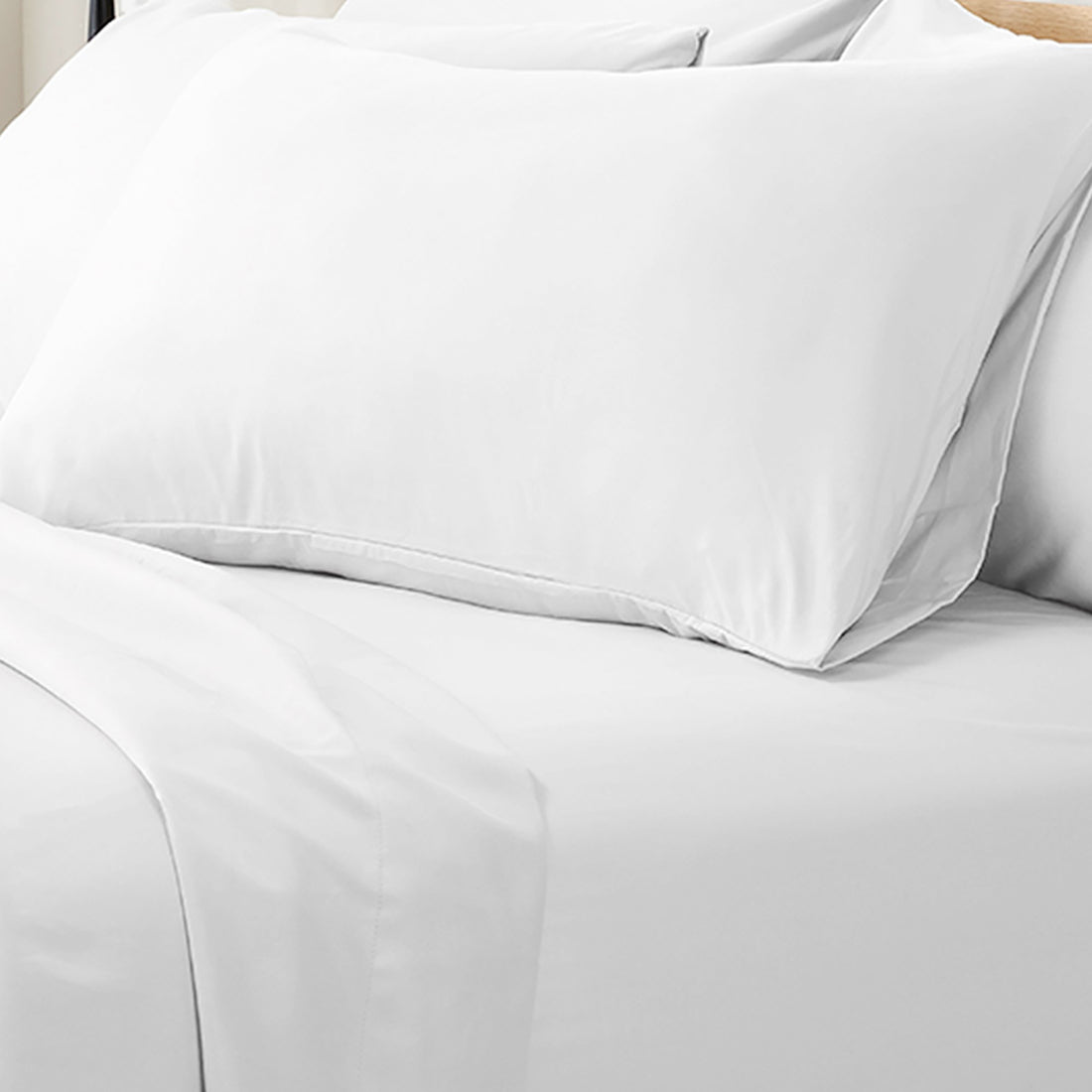 Valeria 1000TC Ultra Soft Bed Sheet Set King Single – White, featuring smooth, neatly laid white sheets on a bed, complemented by a neatly placed pillow and cushion, highlighting luxury and comfort.