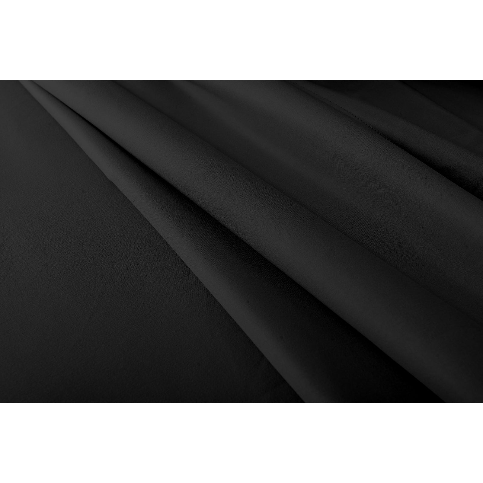 Close-up of the Valeria 1000TC Ultra Soft Bed Sheet Set – Black, showcasing the smooth, high-thread-count black fabric, with a glimpse of a white rectangular object with a black border.