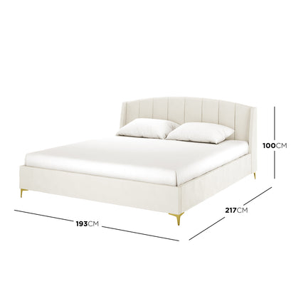 Lyra Velvet Bed Frame with Winged Headboard in Cream White King size on display, highlighting its tufted, padded headboard and luxurious velvet finish, set against a furnished bedroom backdrop.