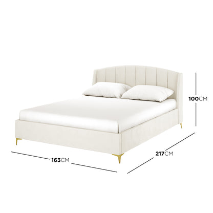 Lyra Velvet Bed Frame with Winged Headboard - Cream White Queen, featuring a tufted, padded headboard and elegant gold chrome legs, sits invitingly on a neatly made bed, exuding luxury and comfort.