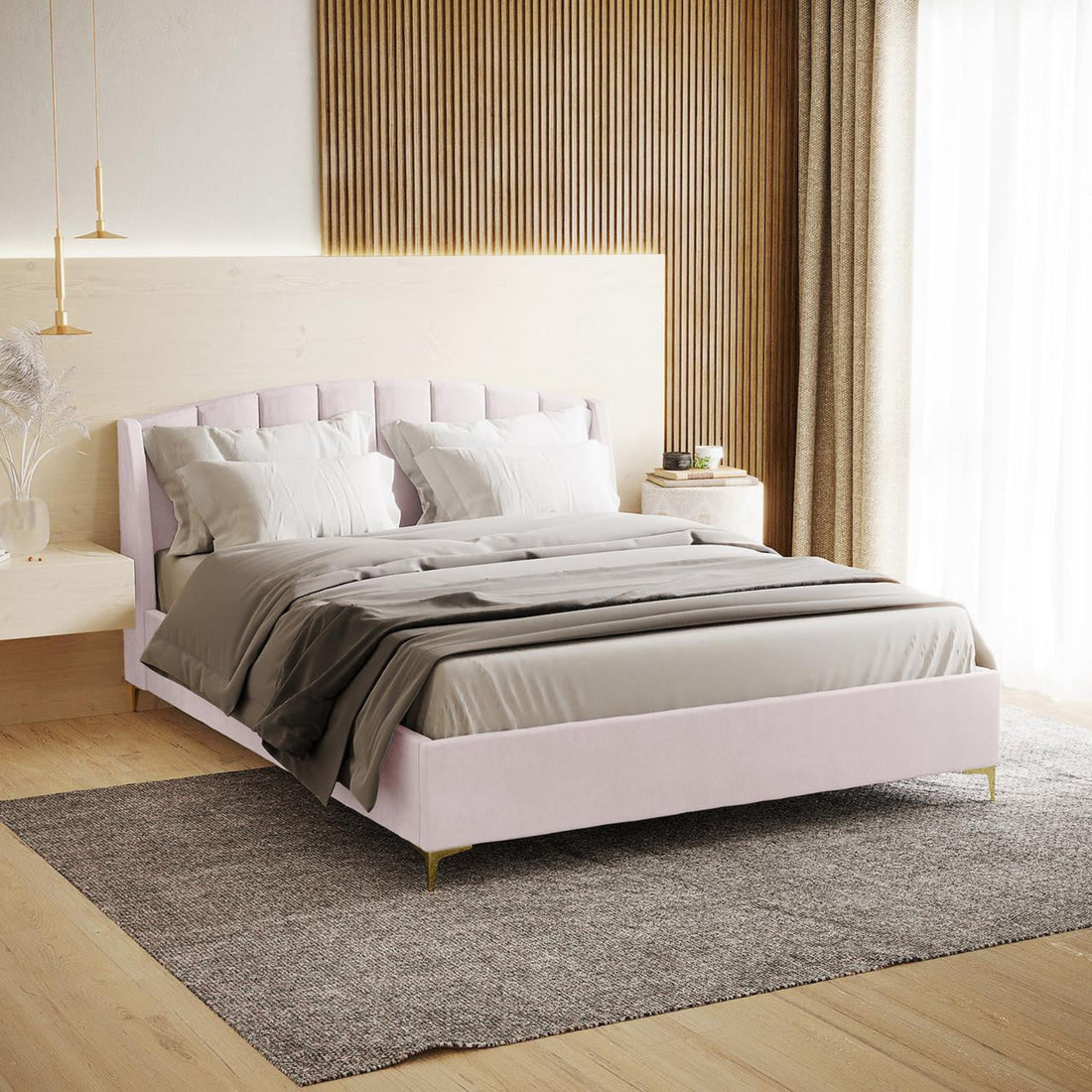 Lyra King Winged Velvet Fabric Bed Frame in Soft Pink with a channel-tufted headboard, gold chrome legs, and neutral bedding in a modern bedroom setting.