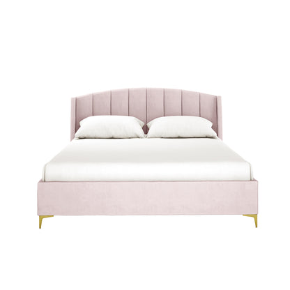 Lyra Velvet Bed Frame with Winged Headboard - Soft Pink King, featuring a blush-pink channel-tufted headboard, low footboard, white bedding, and gold-finished legs.