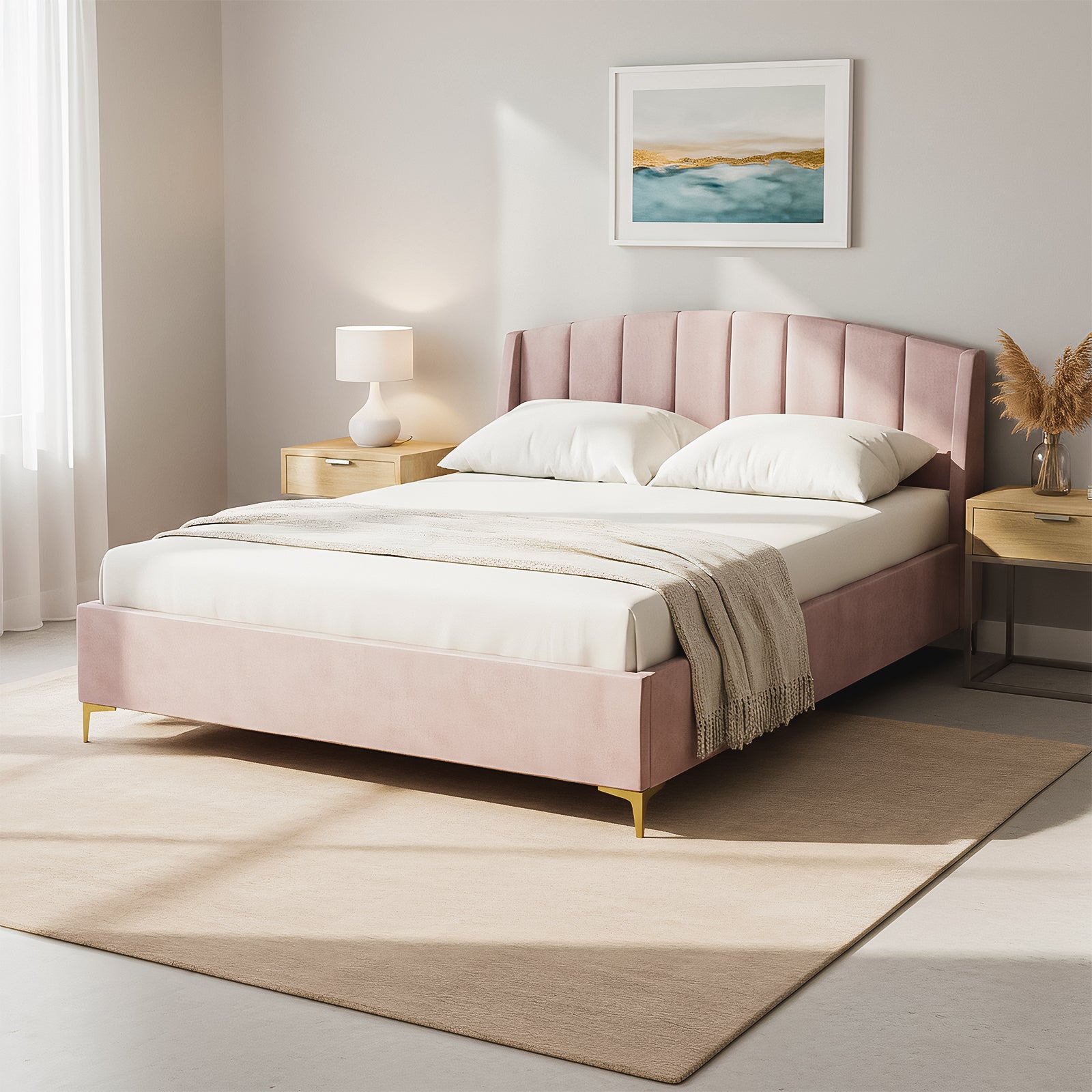 Lyra Queen Winged Velvet Fabric Bed Frame in Soft Pink with a scalloped headboard, white bedding, light-wood nightstands, a ceramic lamp, and pampas grass, all on a neutral-tone rug.