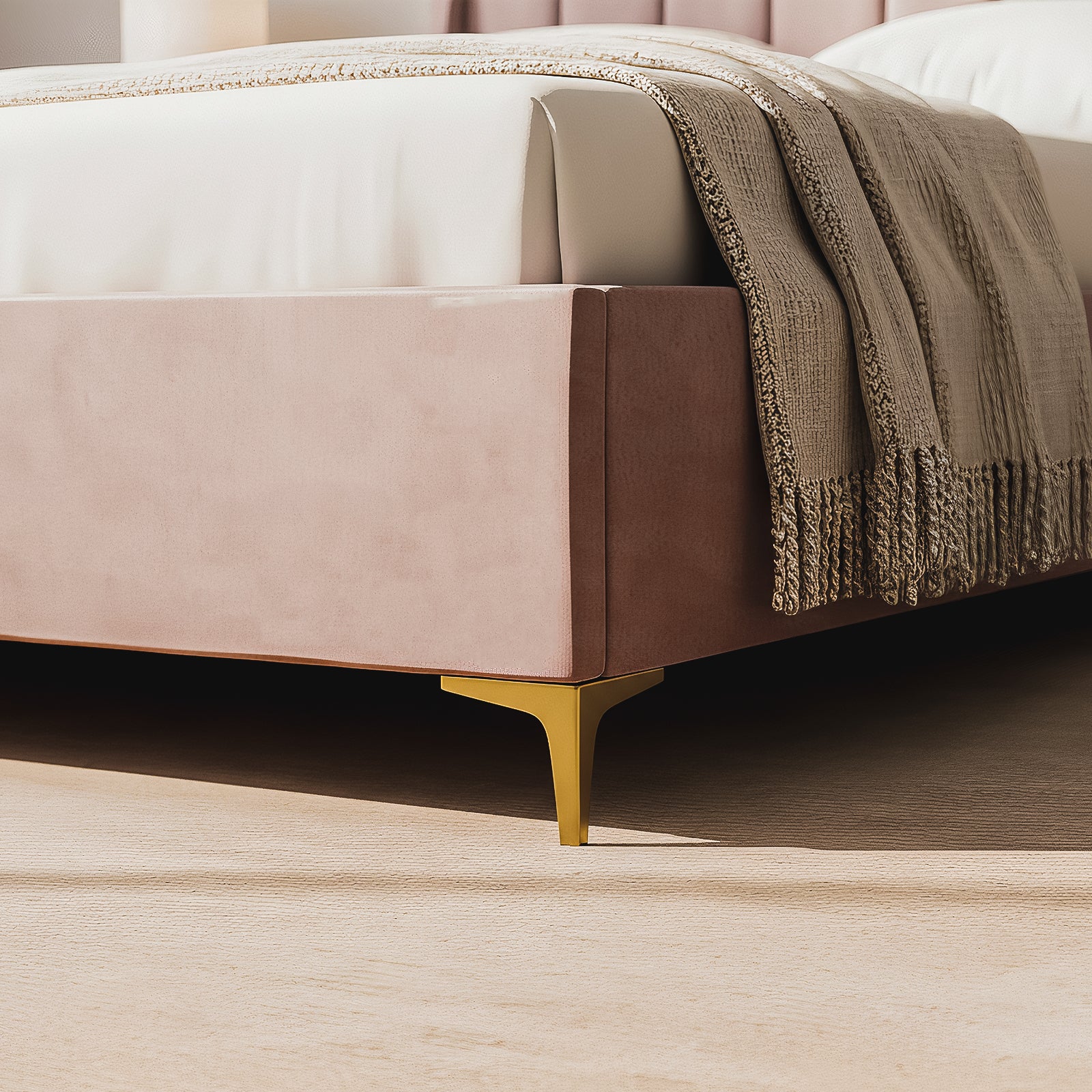 Close-up of the Lyra Queen Winged Velvet Fabric Bed Frame in Soft Pink, showcasing dusty-rose velvet upholstery, a white mattress, oatmeal-colored throw, and gold-toned metal leg on a light wood floor.