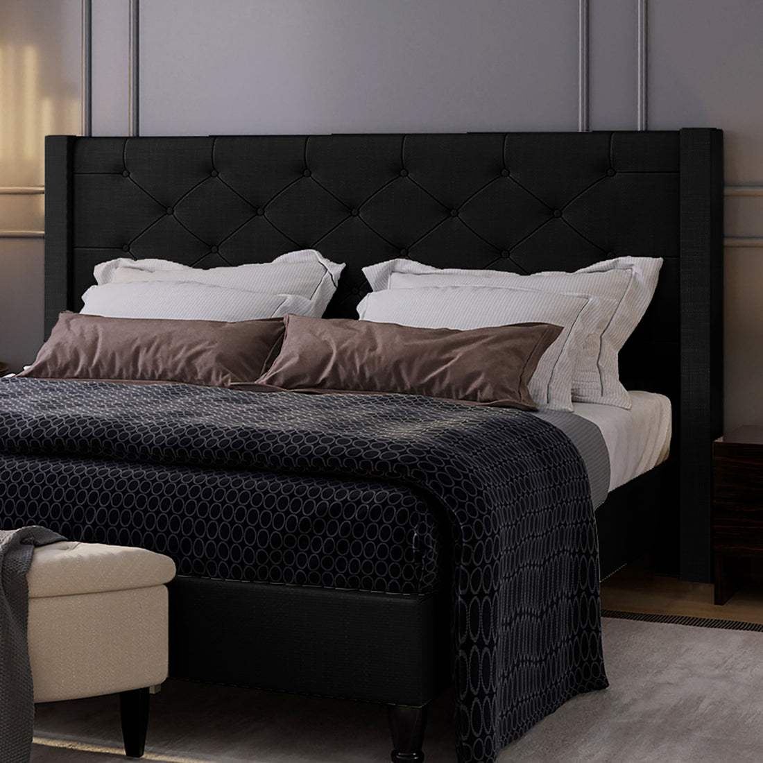 Maggie King Winged Fabric Bed Frame – Black features a grand Chesterfield-style headboard with deep-buttoned detailing, crafted in plush fabric, showcasing a sophisticated blend of classic and contemporary design.