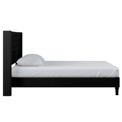 Maggie King Winged Fabric Bed Frame – Black features a close-up of its grand Chesterfield-style headboard with deep-buttoned upholstery, showcasing its elegant design and robust construction for luxurious bedroom appeal.