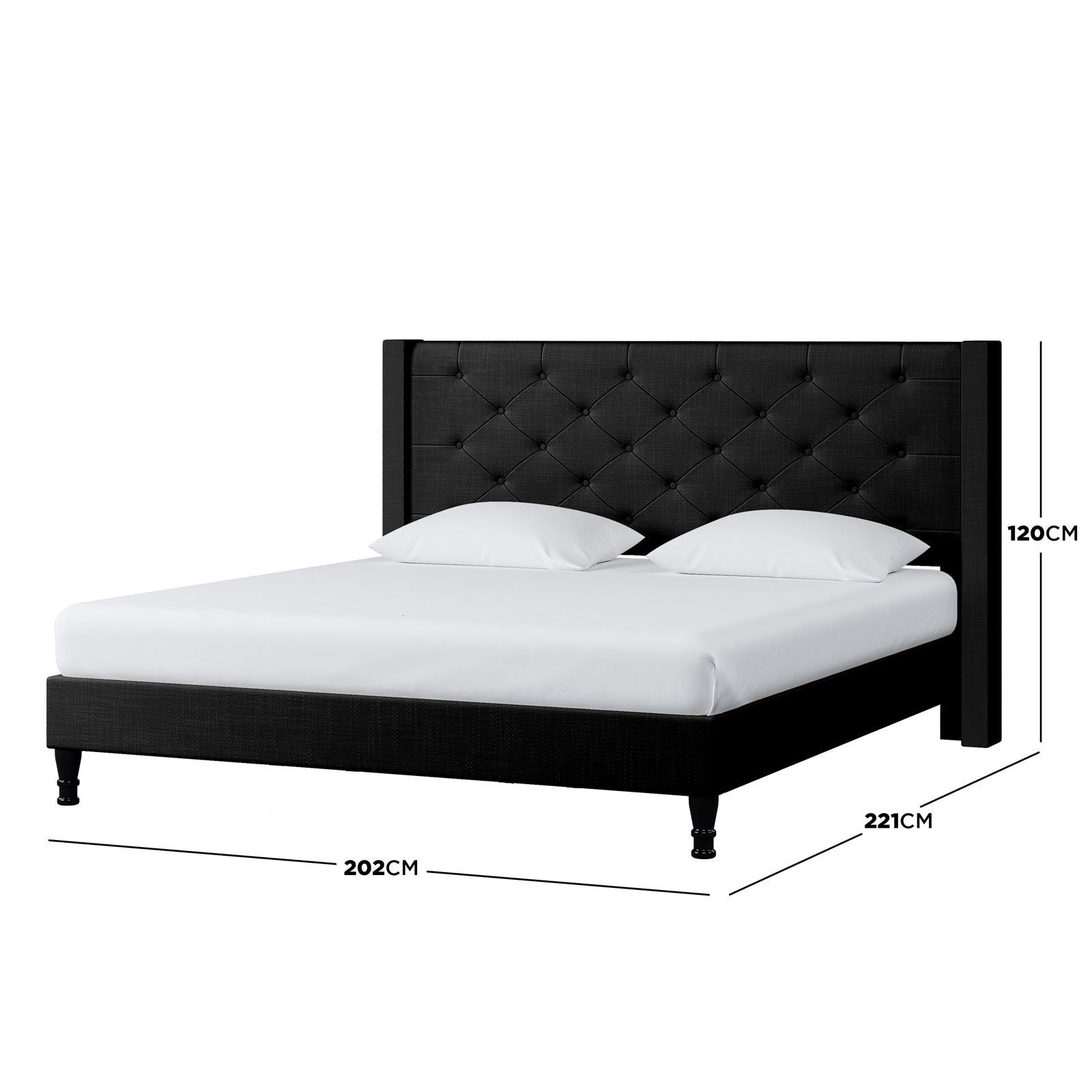 Maggie King Winged Fabric Bed Frame – Black, showcasing a plush Chesterfield-style headboard with deep-buttoned design, set against a black surface with coordinated white pillows and sheets.