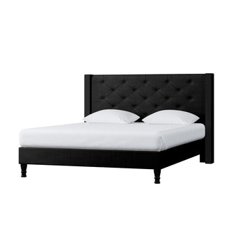 Maggie Queen Winged Fabric Bed Frame – Black features a Chesterfield-style headboard, plush with deep-buttoning. The black bed frame pairs elegantly with white pillows, enhancing bedroom sophistication and modern appeal.