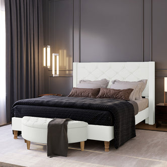 Maggie Queen Winged Fabric Bed Frame in Off White with a tufted headboard, surrounded by neutral pillows, a dark coverlet, and a white bench with a dark throw at the foot.