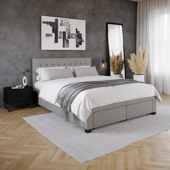 Martina Queen Fabric Bed with Storage Drawers – Ash, featuring a grid-tufted headboard, visible storage drawers, and soft upholstery, set in a modern bedroom interior with a black nightstand and artwork.