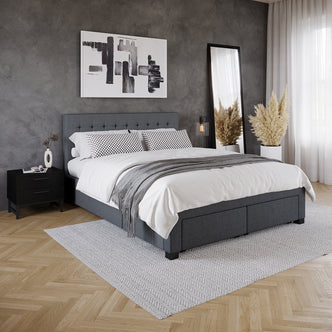 Martina Queen Fabric Bed with Storage Drawers – Dark Grey featuring a grid-tufted headboard and four integrated storage drawers, complemented by a dark grey linen-like fabric, showcased beside a black nightstand and indoor plant.
