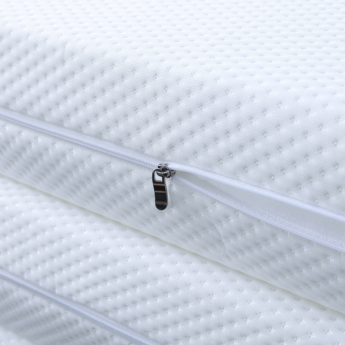 Close-up of the Flecter Foldable Foam Mattress - Queen, showcasing precise stitching on the white fabric and a durable zipper, highlighting craftsmanship and attention to detail.