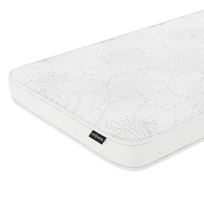 Gydas 10cm High-Density Foam Knitted Nursery Cot Mattress with quilt-patterned surface, viewed at an angle, showcasing stitched details and side label for gentle comfort and certified safety.