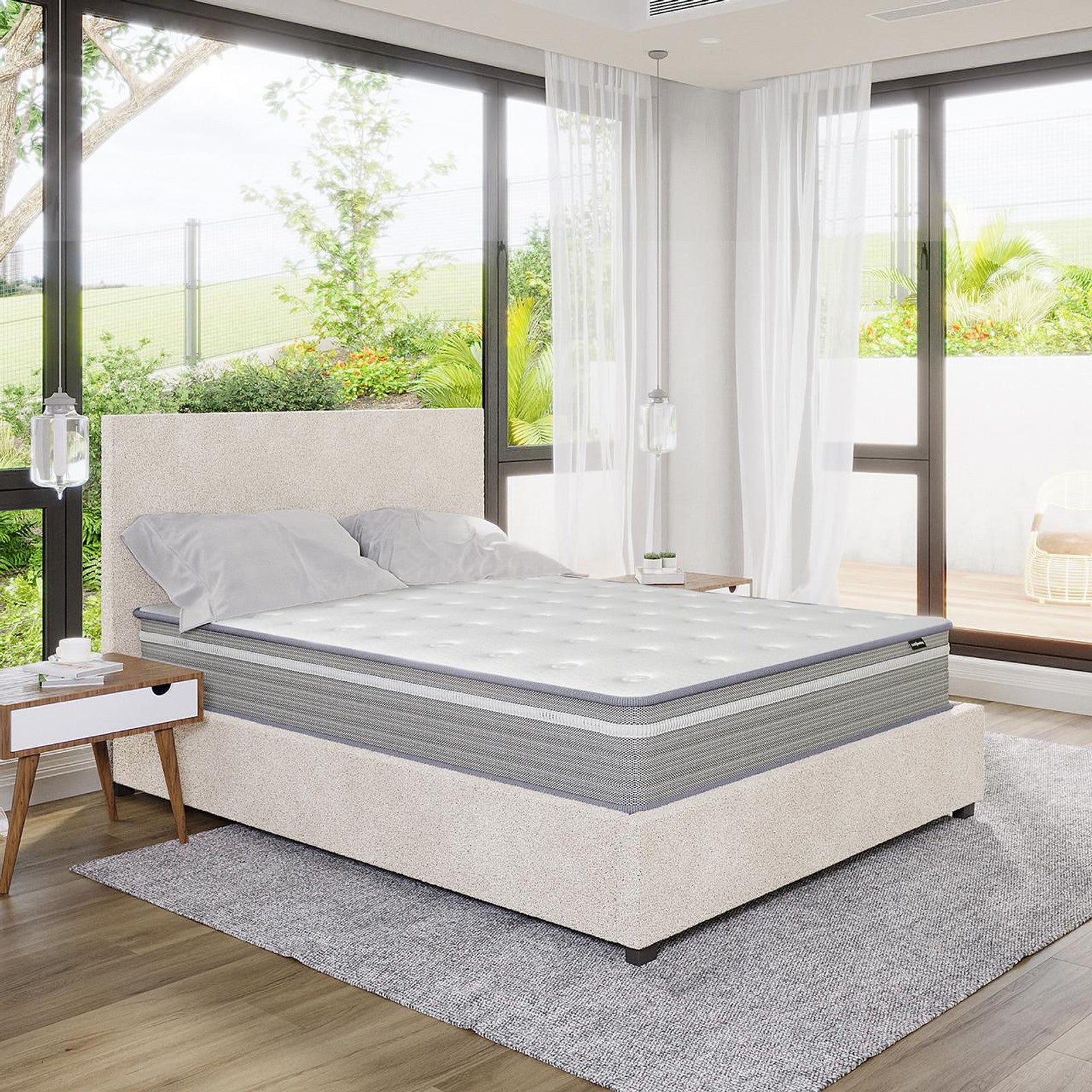 Oriona Double 25cm Pocket Spring Gel Mattress in Medium Firm on a low-profile upholstered bed, showcasing a tufted design, complemented by mid-century nightstands and glass pendant lights in a bright bedroom setting.