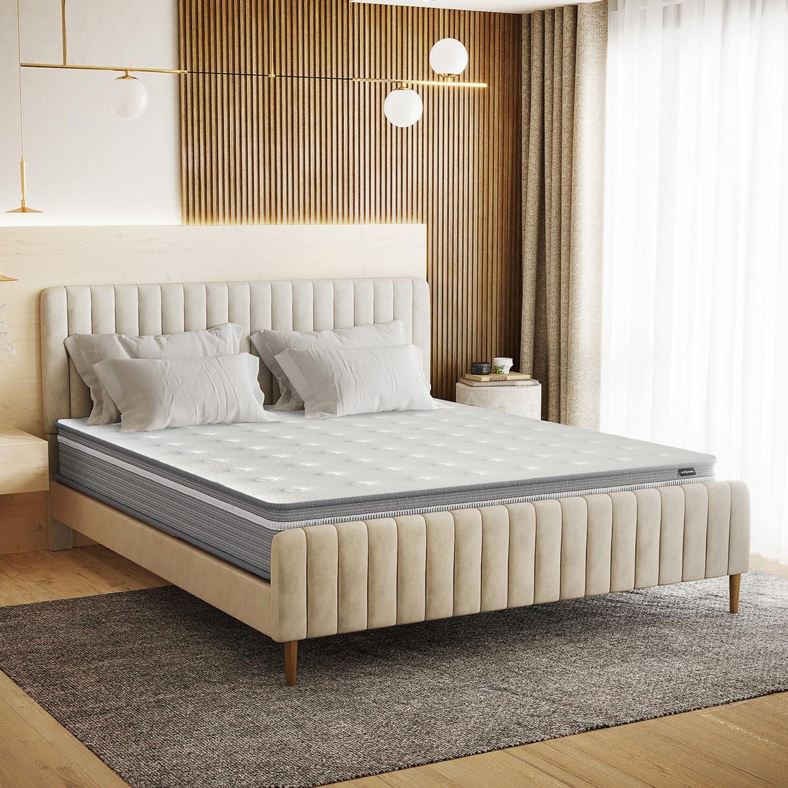 Oriona King 25cm Pocket Spring Gel Mattress in Medium Firm on a low platform bed, featuring a white quilted top, gray sides, and four pillows. Positioned within a modern bedroom setting.