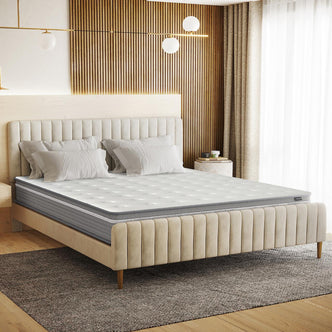 Oriona Super King 25cm Pocket Spring Mattress in Med Firm on an upholstered bed frame, adorned with white pillows and a quilted topper, set in a serene bedroom with elegant lighting and decor.