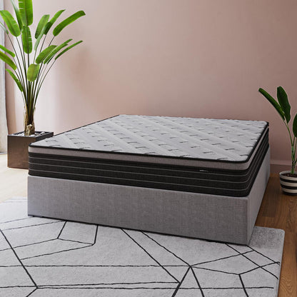 Phoebe King 33cm Euro Pillow Top Pocket Spring Mattress displayed in a minimalist bedroom, featuring a gray upholstered base, patterned cover, and surrounded by greenery, showcasing its luxurious comfort and contemporary design.