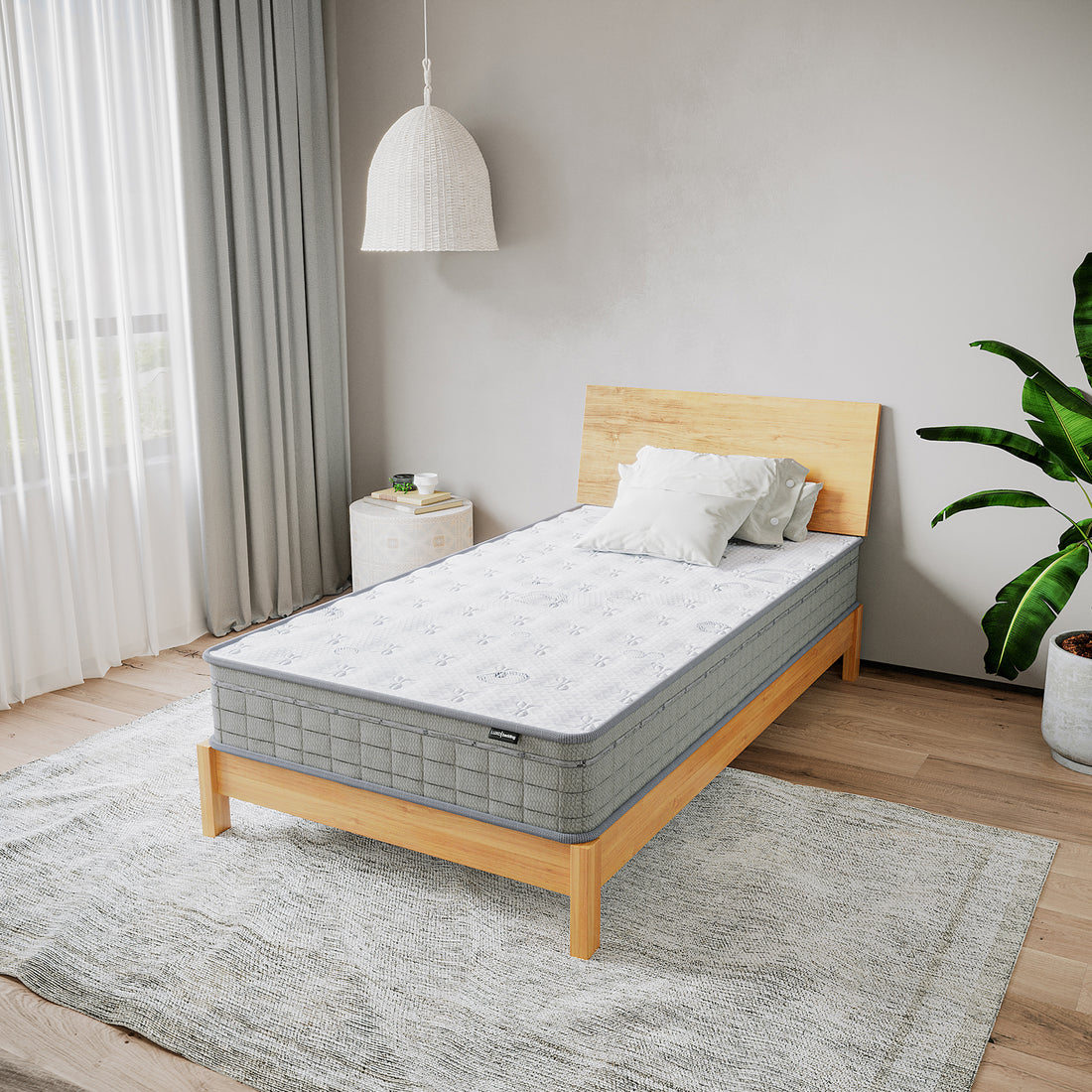Thetis King Single 25cm Pocket Spring Latex Mattress on a minimalist wooden bed, styled with white pillows and neutral decor, featuring a woven pendant lamp and a potted plant for a serene bedroom vibe.