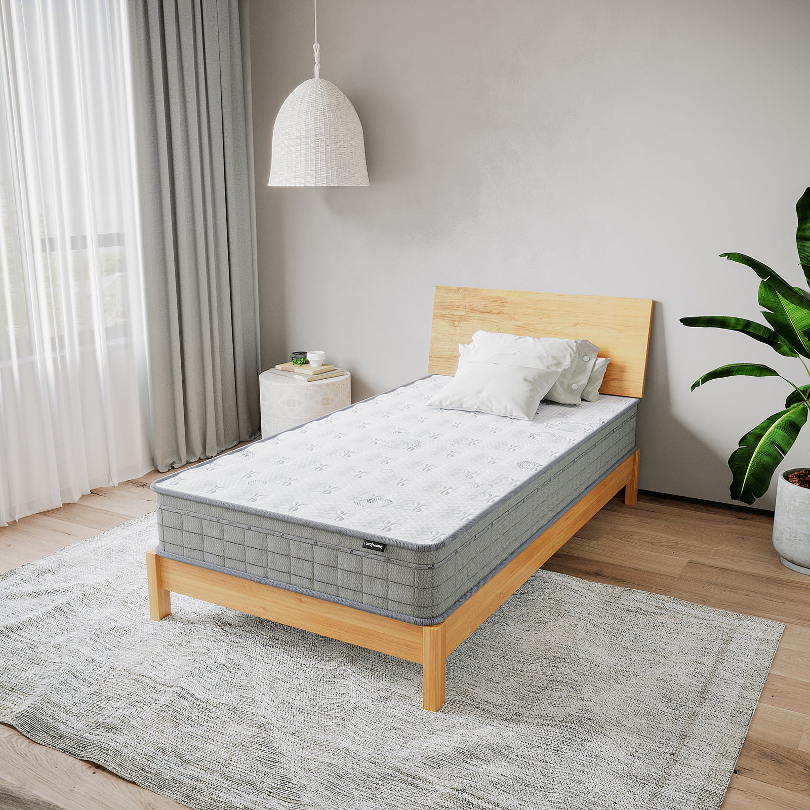 Thetis King Single 25cm Pocket Spring Latex Mattress on a minimalist wooden bed, styled with white pillows and neutral decor, featuring a woven pendant lamp and a potted plant for a serene bedroom vibe.