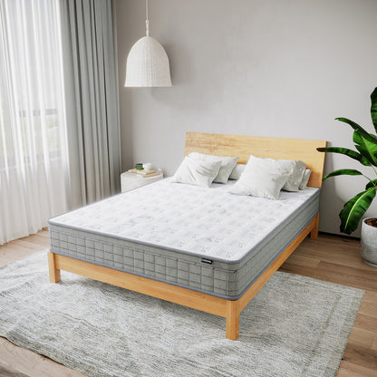 Thetis Queen 25cm Pocket Spring Latex Mattress in Med Firm on a wooden bed frame, surrounded by white pillows, light gray rug, side table, woven pendant lamp, sheer curtains, and a tall green plant.