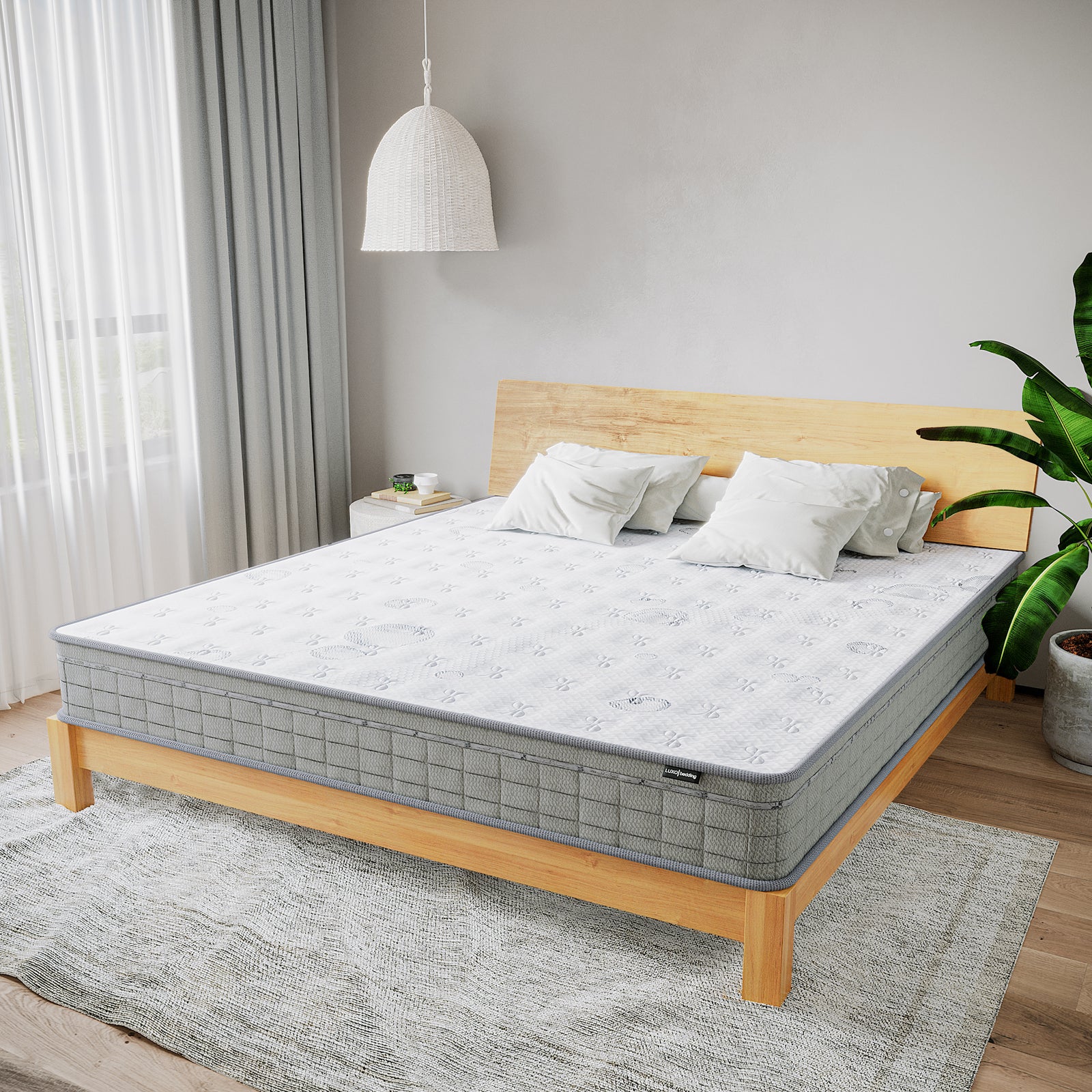 Thetis Super King 25cm Pocket Spring Latex Mattress on a low wooden-frame bed, with off-white pillows against a wooden headboard. Nearby, a bedside table with books and a cup, enhancing a serene bedroom atmosphere.