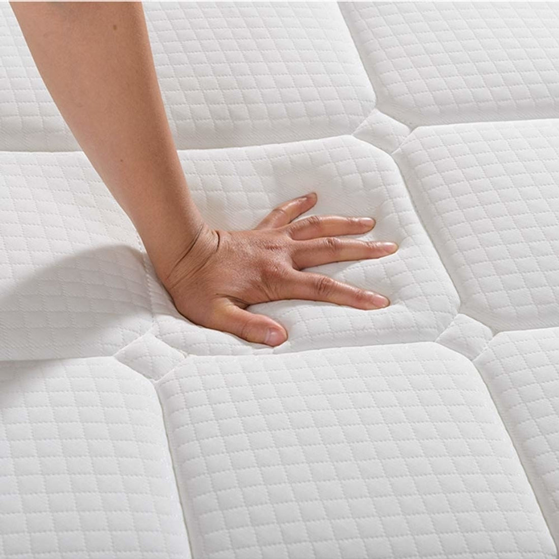 Hand pressing Luxo Venus Double Firm Pocket Spring Pillow Top Mattress, showcasing thick pocket springs and firm foam top for support. Emphasizes durable, breathable fabric cover and reinforced edges for lasting performance.