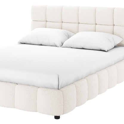 Nikias Double Boucle Fabric Bed Frame in Cream White features a low-profile, fully upholstered design with a grid-tufted headboard and rounded base, complemented by fitted white bedding for a luxurious look.
