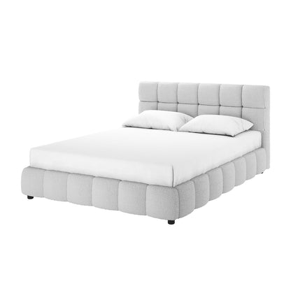 Nikias Queen Bouclé Fabric Bed Frame in Light Grey features a low-profile design with a tall, square-tufted headboard and matching pillows, all upholstered in textured light fabric, on short dark legs.