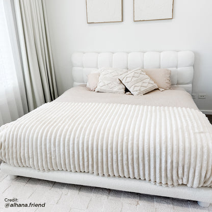 Nikias Super King Boucle Fabric Bed Frame in Cream White features a plush, tufted headboard with bouclé upholstery, set in a serene bedroom with abstract art, sheer curtains, and textured pillows.