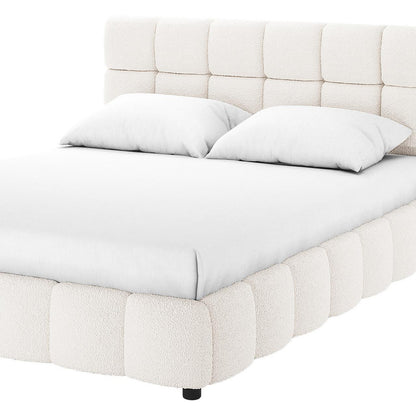 Nikias Super King Boucle Fabric Bed Frame in Cream White, featuring a low-profile design with a tufted, square-paneled headboard and sides in soft bouclé fabric, dressed with white bedding.