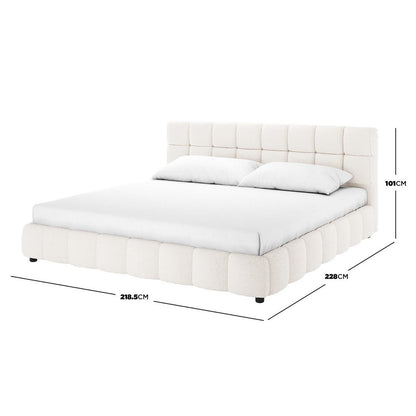 Nikias Super King Boucle Fabric Bed Frame in Cream White features a square-tufted headboard and base in boucle fabric, modern silhouette with short black feet, shown with a mattress and pillows.
