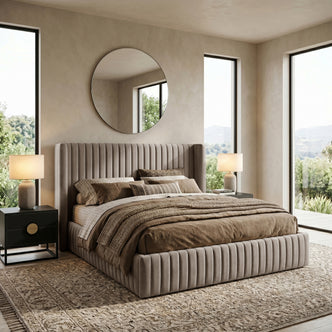 Warm grey king bed neatly made in a bright, styled bedroom