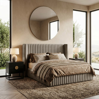 Warm grey queen bed neatly made in a bright, styled bedroom