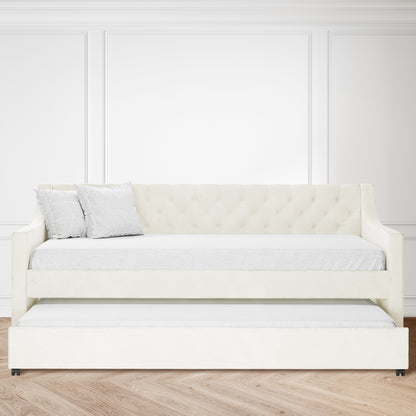 Ovidia Velvet Single Sofa Daybed with Trundle in Cream White, featuring tufted backrest and two throw pillows, set against white paneled walls and light herringbone wood floor, showcasing elegance and functionality.