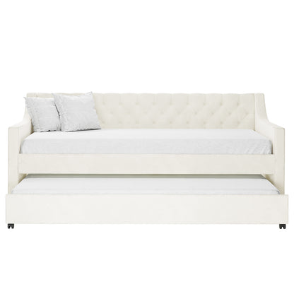 Ovidia Velvet Single Sofa Daybed with Trundle in Cream White features a tufted backrest, sloped arms, matching pillows, and a pull-out trundle, offering stylish, space-saving functionality.