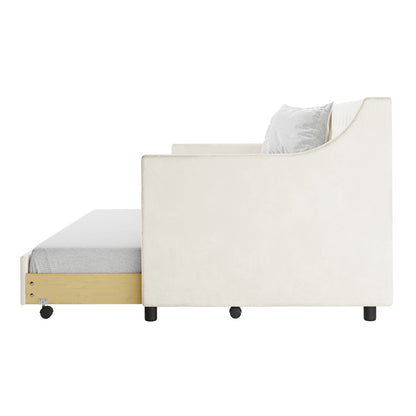 Ovidia Velvet Single Sofa Daybed with Trundle in Cream White features a white upholstered armchair-style sofa with a pull-out trundle bed, light wood frame, thin mattress, and caster wheels.