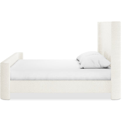 Palmira King Boucle Fabric Bed Frame in Cream White, featuring a tall headboard, shorter footboard, low side rail, and neutral-toned fitted sheet and pillows, creating an elegant bedroom centerpiece.
