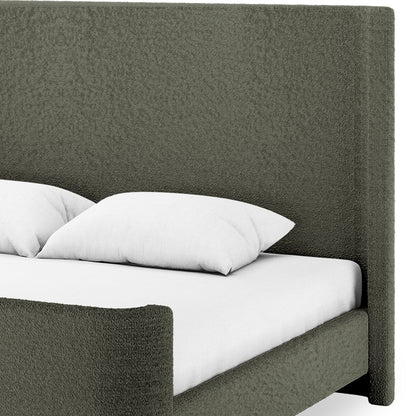 Palmira King Boucle Fabric Bed Frame in Dark Green featuring a tall squared headboard and footboard in muted olive-green fabric with a white mattress and pillows on top.